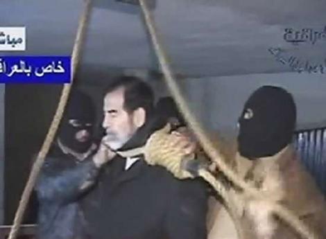A frame grab from Iraqi state televison shows a noose being placed
around Saddam Hussein's neck.